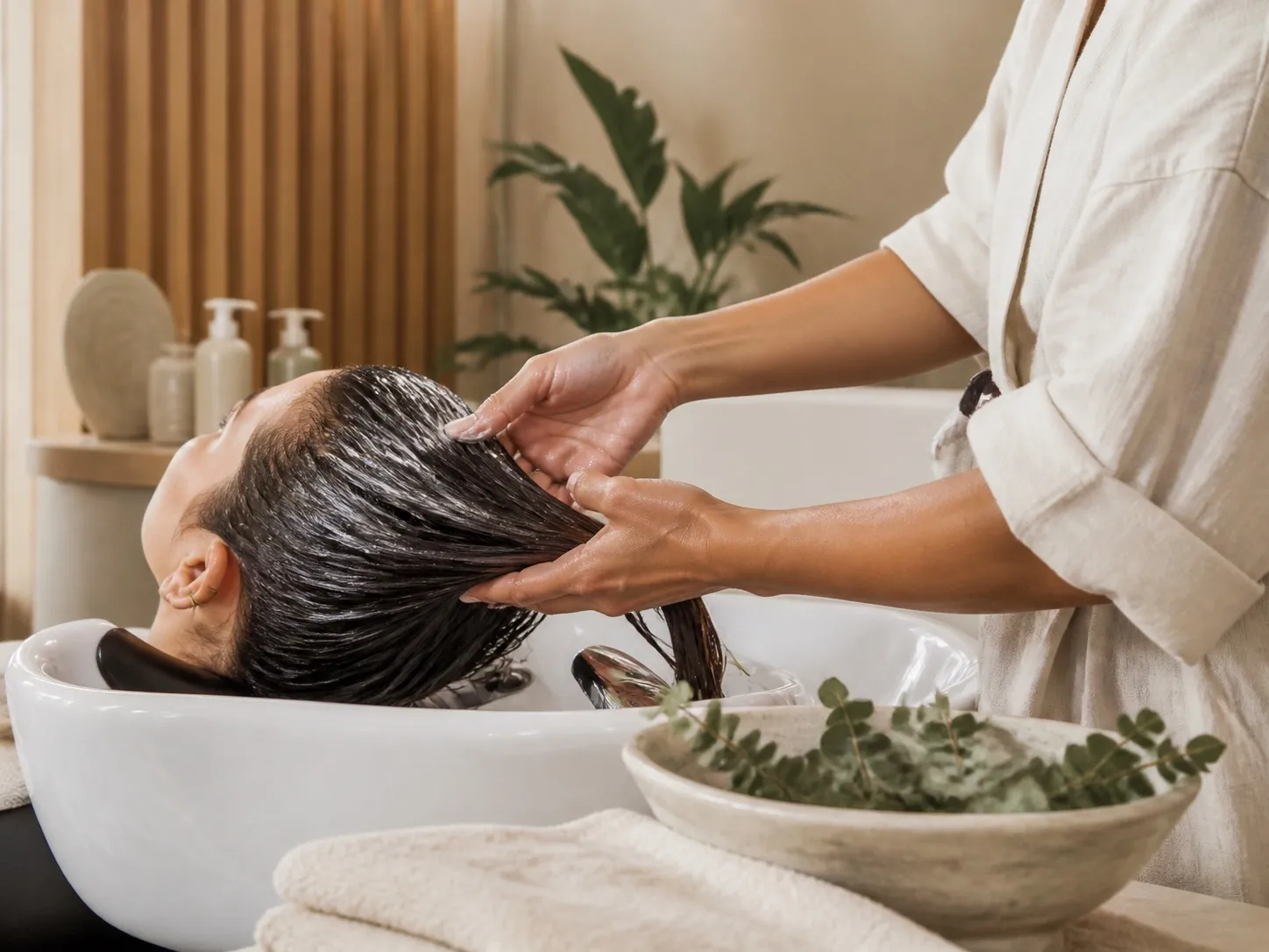 Professional applying a restorative hydration treatment.